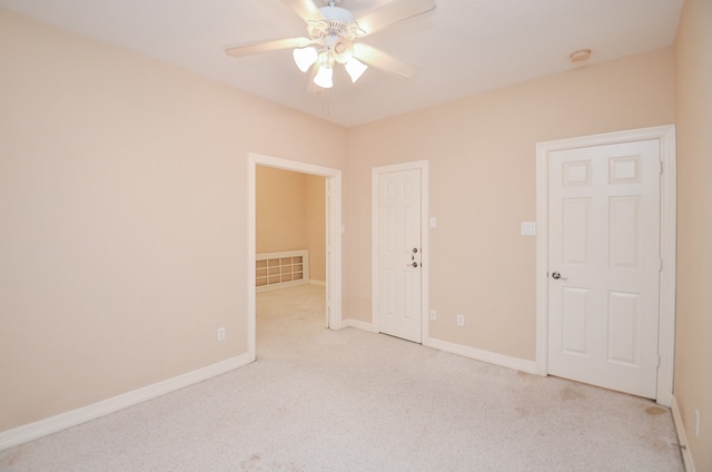 spare room with light carpet and ceiling fan