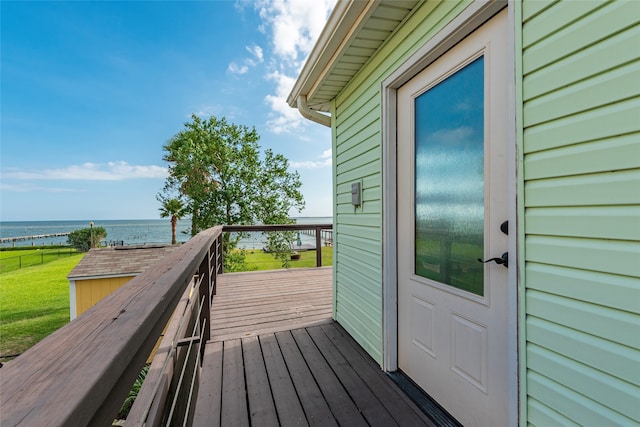 deck featuring a yard and a water view