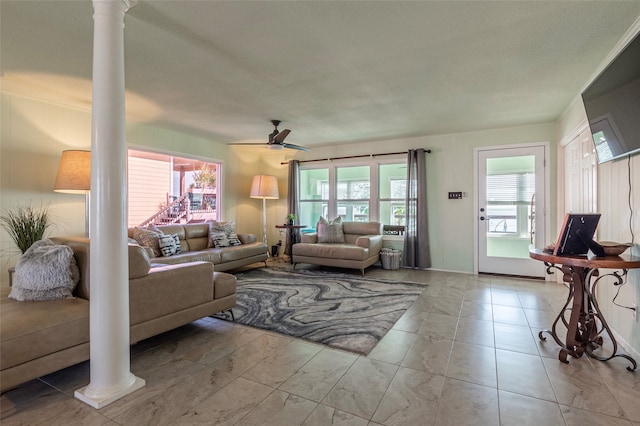 living room featuring ceiling fan and decorative columns