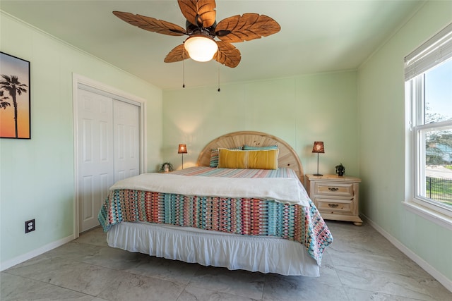 bedroom with a closet, ornamental molding, and ceiling fan