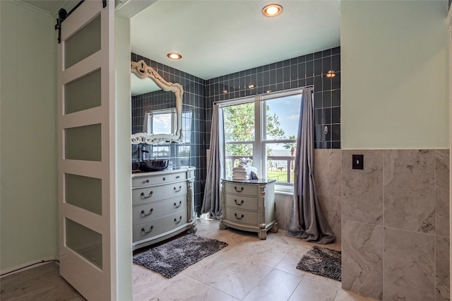 bathroom featuring tile patterned flooring and tile walls