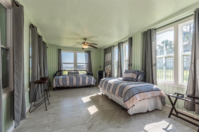 bedroom with multiple windows and ceiling fan