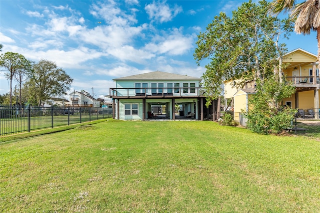 back of property featuring a lawn and a wooden deck