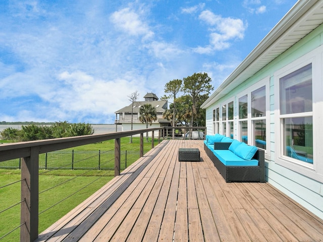 wooden terrace featuring outdoor lounge area and a lawn