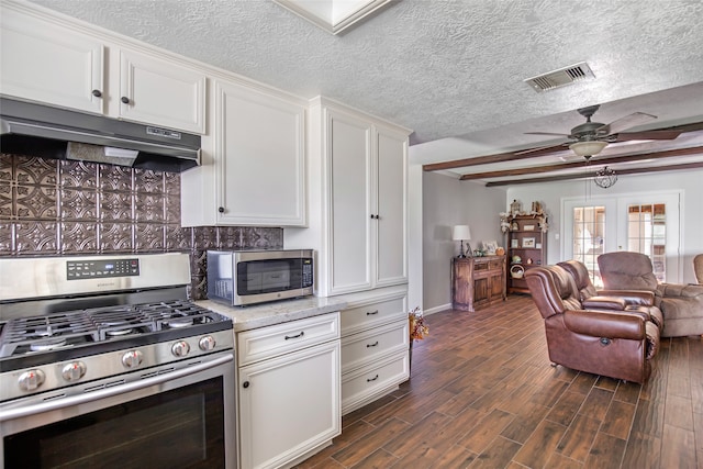 kitchen featuring stainless steel appliances, dark hardwood / wood-style floors, white cabinetry, and ceiling fan