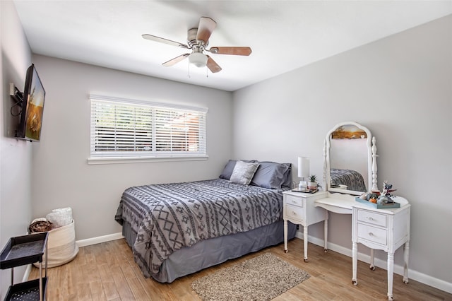 bedroom with light hardwood / wood-style floors and ceiling fan