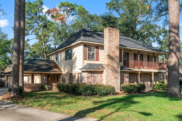 view of front of home with a balcony and a front lawn