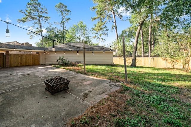 view of yard featuring a fire pit and a patio area