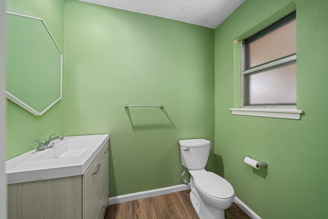 bathroom featuring hardwood / wood-style floors, vanity, a textured ceiling, and toilet