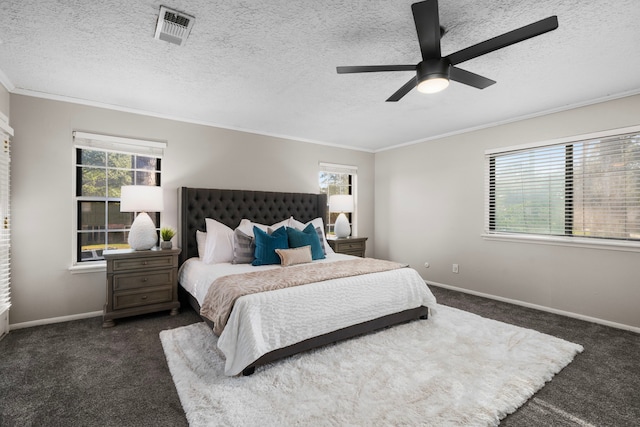 carpeted bedroom with ceiling fan, ornamental molding, and a textured ceiling