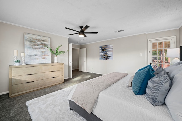 bedroom featuring dark colored carpet, ceiling fan, ornamental molding, and a textured ceiling