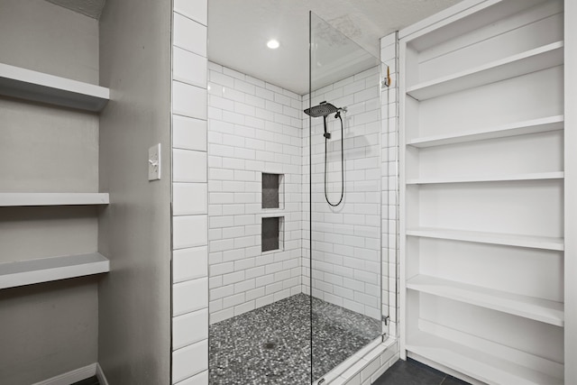 bathroom featuring tile patterned floors and tiled shower