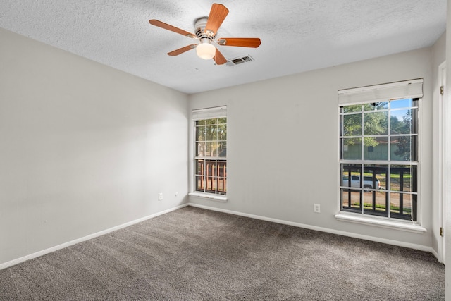 carpeted spare room with a textured ceiling and ceiling fan