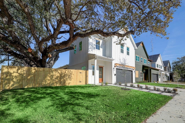 view of front of home featuring a garage and a front yard