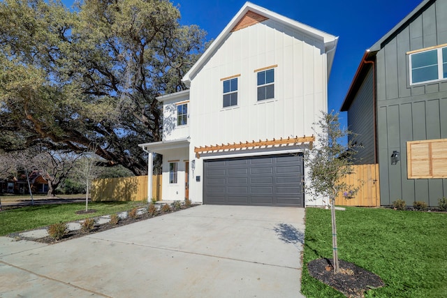 view of front of home with a garage and a front lawn