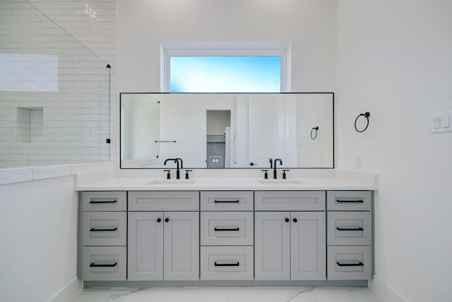 bathroom featuring tiled shower and vanity