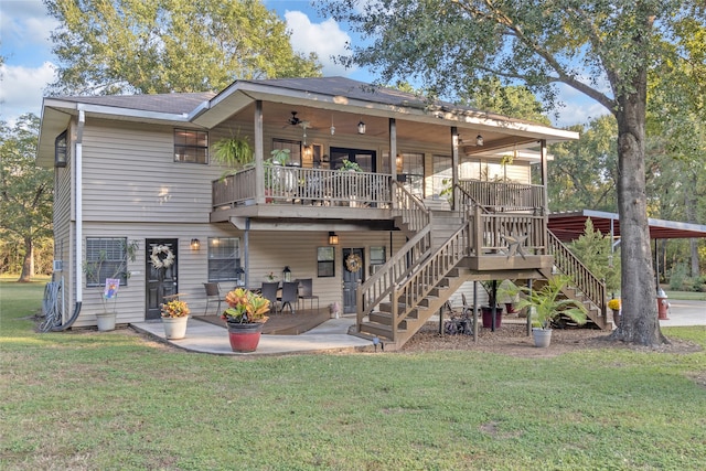 rear view of property with a lawn, ceiling fan, and a patio area