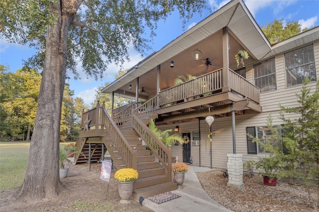 back of property with a wooden deck and ceiling fan