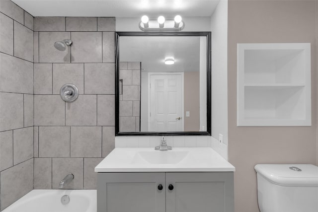 full bathroom featuring vanity, toilet, and tiled shower / bath