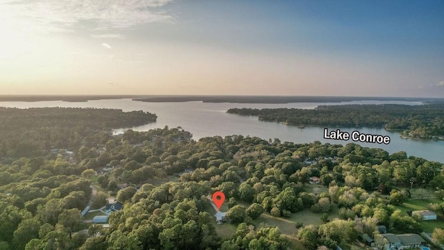 aerial view at dusk featuring a water view