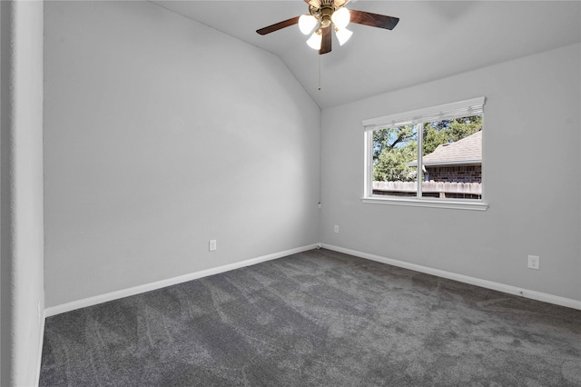 unfurnished room with lofted ceiling, ceiling fan, and dark colored carpet