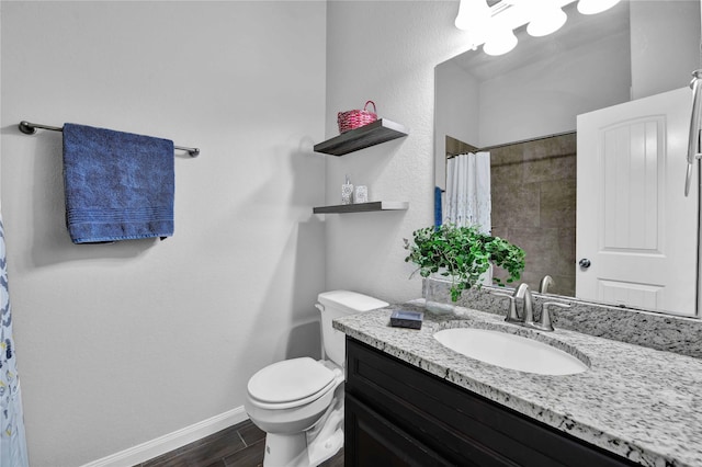 bathroom with vanity, hardwood / wood-style flooring, toilet, and walk in shower