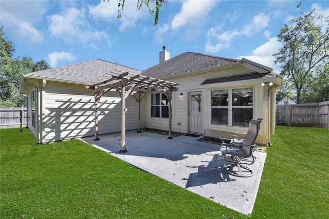 back of property with a patio, a lawn, and a pergola