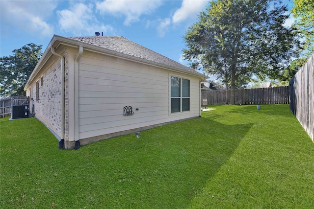 exterior space with central AC unit and a lawn