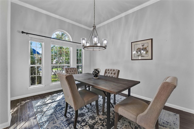 dining space featuring dark hardwood / wood-style flooring, ornamental molding, and a chandelier