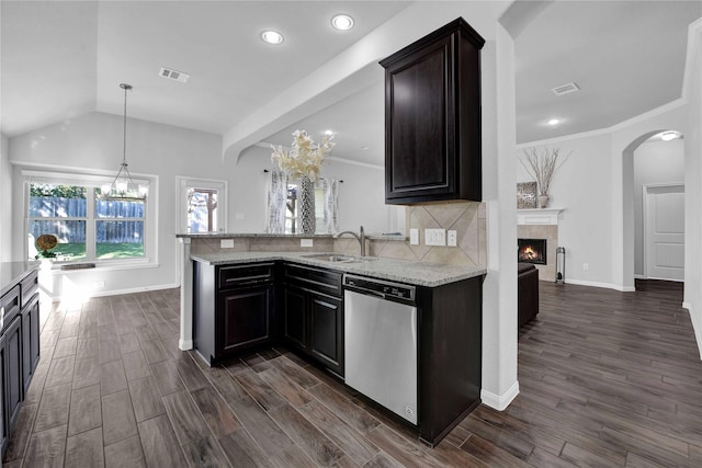 kitchen with dishwasher, sink, dark wood-type flooring, and a fireplace