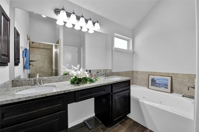 bathroom with vanity, vaulted ceiling, and plus walk in shower