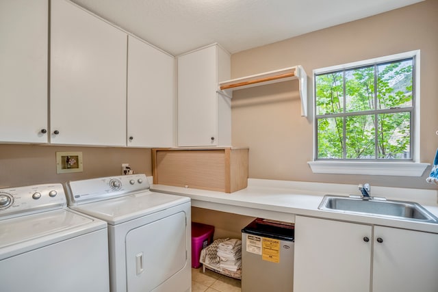 washroom featuring washer and clothes dryer, a textured ceiling, light tile patterned floors, cabinets, and sink