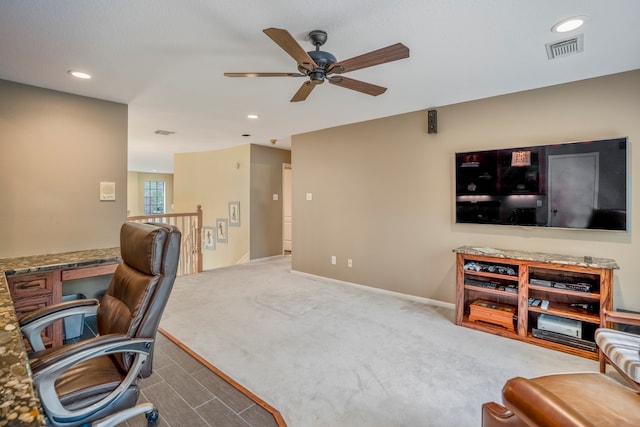 carpeted office featuring ceiling fan