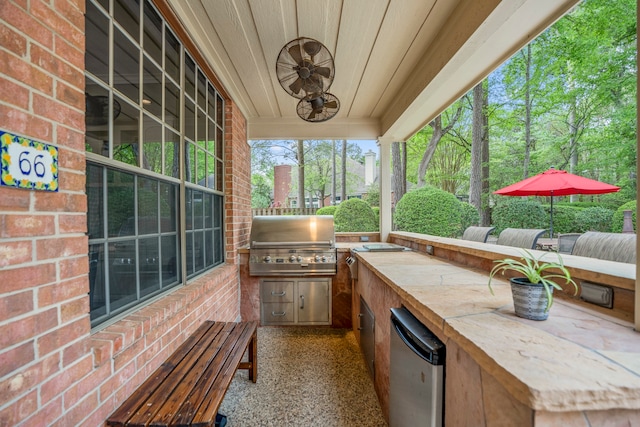 view of patio / terrace featuring an outdoor kitchen and a grill