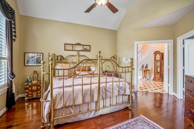 bedroom with wood-type flooring, ceiling fan, and vaulted ceiling