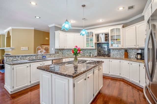 kitchen with white cabinets, sink, dark wood-type flooring, and a kitchen island