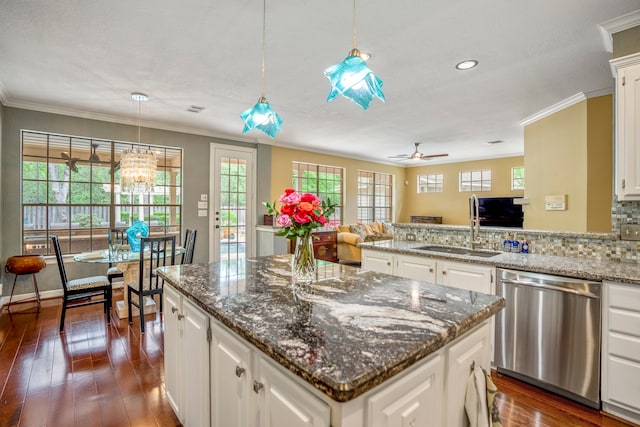 kitchen with white cabinetry, sink, dishwasher, pendant lighting, and dark hardwood / wood-style flooring