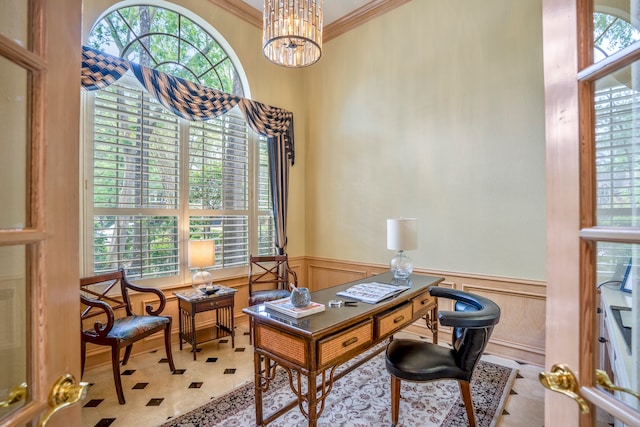 office area featuring a healthy amount of sunlight, an inviting chandelier, and ornamental molding