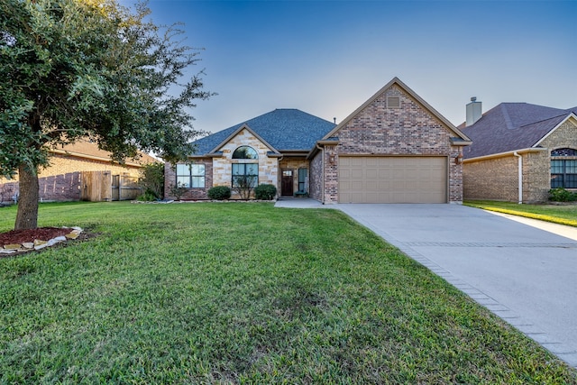 view of front facade featuring a garage and a front lawn