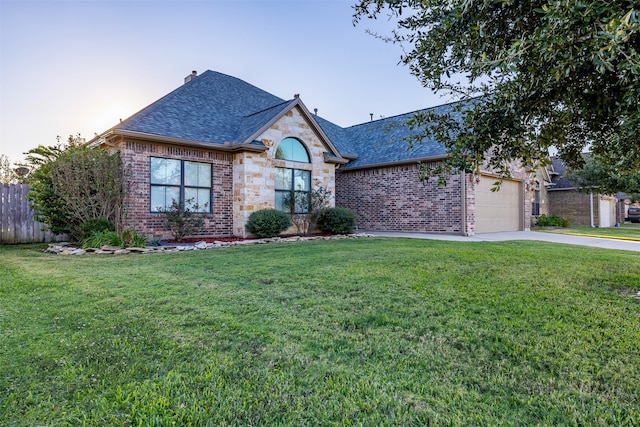 view of front of house with a garage and a lawn