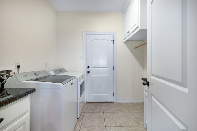 washroom featuring cabinets, light tile patterned floors, and separate washer and dryer