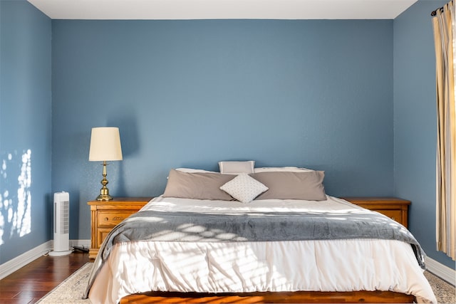 bedroom featuring dark hardwood / wood-style flooring