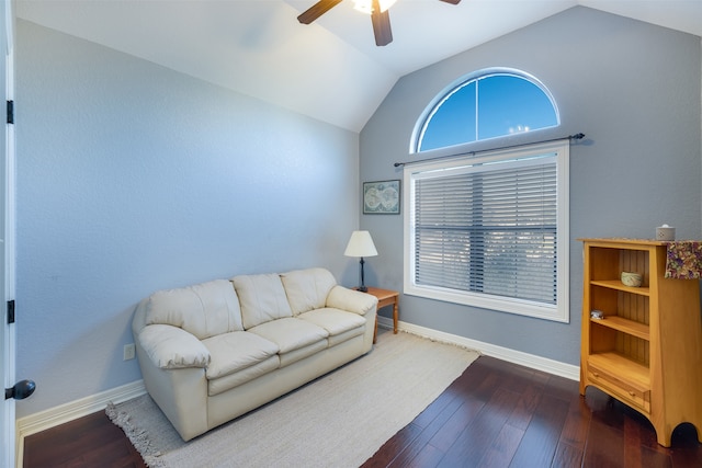 living room featuring dark wood-type flooring, ceiling fan, and vaulted ceiling