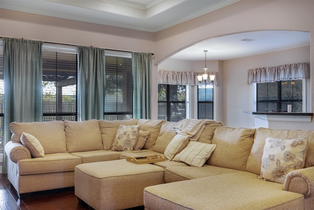 living room with crown molding, dark hardwood / wood-style flooring, and a notable chandelier