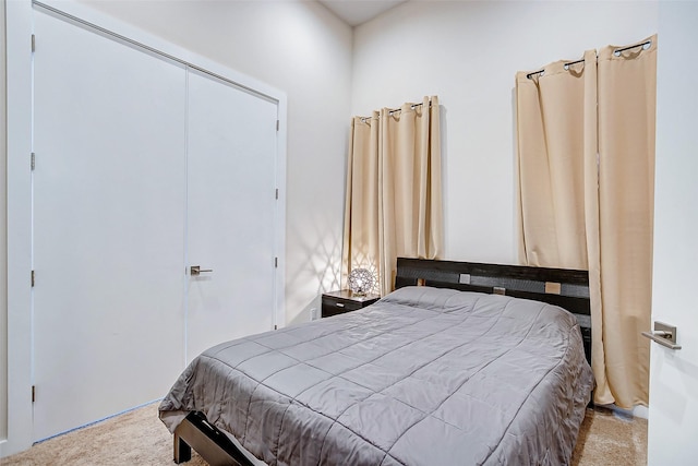 bedroom featuring light carpet and a closet