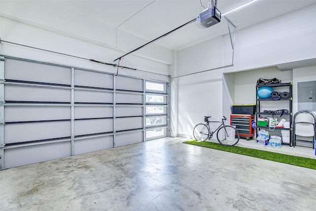 garage featuring electric panel and a garage door opener