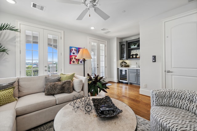 living room with french doors, hardwood / wood-style flooring, wine cooler, and ceiling fan