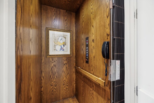 room details featuring wooden walls and elevator