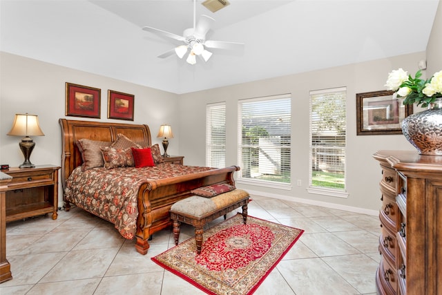 bedroom with ceiling fan, light tile patterned floors, and vaulted ceiling