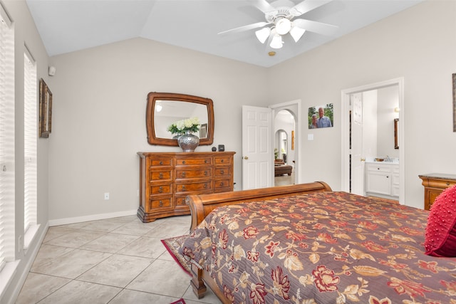 tiled bedroom with ceiling fan, vaulted ceiling, and ensuite bath